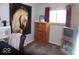 Bedroom featuring a wooden dresser, window with red curtains, and horse picture on the wall at 213 S Coventry Dr, Anderson, IN 46012