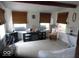 Bright sunroom featuring neutral decor, ample natural light, and cozy seating area at 213 S Coventry Dr, Anderson, IN 46012