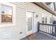 Inviting balcony with light blue siding, and a welcome mat near the doorway at 2230 N Pennsylvania N St # 7, Indianapolis, IN 46205