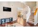 Cozy living area showcasing hardwood floors, adjacent kitchen view, and staircase at 2230 N Pennsylvania N St # 7, Indianapolis, IN 46205