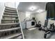 Finished basement with stairs and a laundry area featuring modern washer, dryer and exercise equipment at 250 N 18Th Ave, Beech Grove, IN 46107