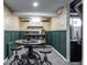 Finished basement features a small bar area with seats and a refrigerator at 250 N 18Th Ave, Beech Grove, IN 46107