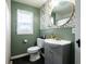 Stylish bathroom features green walls, a vanity, a toilet, and a shower with a curtain at 250 N 18Th Ave, Beech Grove, IN 46107
