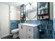 This bathroom features blue backsplash, storage cabinets and drawers, and a vanity at 250 N 18Th Ave, Beech Grove, IN 46107