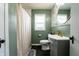 This bathroom includes a vanity with a stylish mirror, a toilet, and a shower with a curtain at 250 N 18Th Ave, Beech Grove, IN 46107
