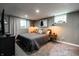 Finished basement bedroom includes gray walls, a window, a bed and matching nightstands at 250 N 18Th Ave, Beech Grove, IN 46107