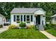Charming home featuring well-manicured lawn, flower boxes and vibrant landscaping at 250 N 18Th Ave, Beech Grove, IN 46107
