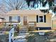 Attractive single-story home featuring a covered porch, wood siding, and neat landscaping at 2523 S Mcclure St, Indianapolis, IN 46241