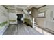 Spacious living room featuring new floors, staircase, and abundant natural light at 2955 N Olney St, Indianapolis, IN 46218