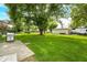 Backyard with patio area, a grill, mature trees, and an RV for outdoor living at 3210 Flintwood Dr, Columbus, IN 47203