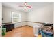 Cozy bedroom with a large window, light walls, and wood floors at 3210 Flintwood Dr, Columbus, IN 47203