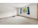 Bright bedroom with neutral carpet and a large window at 3210 Flintwood Dr, Columbus, IN 47203