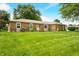 Attractive brick ranch home with lush green lawn and clear blue skies at 3210 Flintwood Dr, Columbus, IN 47203