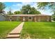 Charming brick ranch home with a well-manicured lawn and inviting walkway at 3210 Flintwood Dr, Columbus, IN 47203
