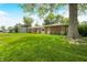 Spacious front yard featuring a well-maintained brick ranch-style home at 3210 Flintwood Dr, Columbus, IN 47203