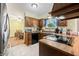 Traditional kitchen with oak cabinets, tile floors and adjacent dining area at 3210 Flintwood Dr, Columbus, IN 47203