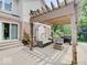 Backyard patio featuring a pergola, seating, and an outdoor kitchen with a barbecue grill at 4075 Dartmoor Dr, Greenwood, IN 46143