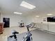 Finished basement with a wet bar, exercise bike, and recreational area, perfect for entertainment and fitness at 4075 Dartmoor Dr, Greenwood, IN 46143