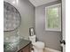 Stylish powder room with a vessel sink, modern fixtures, and tasteful wall decor at 4075 Dartmoor Dr, Greenwood, IN 46143
