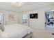 Bright bedroom featuring a walk-in closet, a tray ceiling, and contemporary decor at 4075 Dartmoor Dr, Greenwood, IN 46143