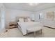Spacious bedroom with a tray ceiling, natural light, and access to an ensuite bathroom at 4075 Dartmoor Dr, Greenwood, IN 46143