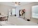 Bright bedroom with a ceiling fan, window, and a clothes rack, creating a cozy space at 4075 Dartmoor Dr, Greenwood, IN 46143