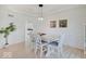 Elegant dining room featuring hardwood floors, tray ceilings, and a modern light fixture at 4075 Dartmoor Dr, Greenwood, IN 46143