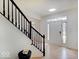 Bright foyer featuring hardwood floors, a staircase, and ample natural light at 4075 Dartmoor Dr, Greenwood, IN 46143