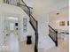 Elegant foyer with a staircase, light hardwood floors, and an open floor plan at 4075 Dartmoor Dr, Greenwood, IN 46143