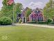 Beautiful two-story brick home featuring a lush green lawn and mature trees at 4075 Dartmoor Dr, Greenwood, IN 46143