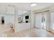 Spacious living room with a fireplace, large windows, and access to a covered porch at 4075 Dartmoor Dr, Greenwood, IN 46143