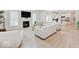 Bright and airy living room with a fireplace and open floor plan, flowing into the kitchen with modern appliances at 4075 Dartmoor Dr, Greenwood, IN 46143