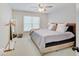 Comfortable main bedroom with a queen bed, soft carpet, natural light from the window, and ceiling fan at 4075 Dartmoor Dr, Greenwood, IN 46143
