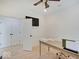 Bright office space featuring a desk, ceiling fan, and access to a large closet for storage solutions at 4075 Dartmoor Dr, Greenwood, IN 46143