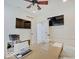Dedicated home office with dual wall-mounted TVs, custom shelving, and ample desk space at 4075 Dartmoor Dr, Greenwood, IN 46143