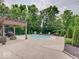 Private swimming pool surrounded by lush greenery and a spacious patio for entertaining at 4075 Dartmoor Dr, Greenwood, IN 46143