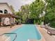 Inviting backyard oasis featuring a private in-ground pool, lounge area, and lush landscaping at 4075 Dartmoor Dr, Greenwood, IN 46143