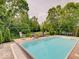 Landscaped backyard featuring a refreshing in-ground pool, perfect for relaxation and recreation at 4075 Dartmoor Dr, Greenwood, IN 46143