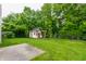 The expansive backyard features lush greenery, a patio, and playhouse, perfect for outdoor fun at 4103 Caddy Way, Indianapolis, IN 46268