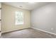 Bedroom featuring neutral carpet, gray walls, and a window that provides natural light at 4103 Caddy Way, Indianapolis, IN 46268