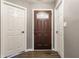 Hallway featuring paneled doors and wood floors that add a sense of sophistication and warmth at 4103 Caddy Way, Indianapolis, IN 46268