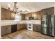 A kitchen with white countertops, stainless steel appliances and pendant lighting at 4103 Caddy Way, Indianapolis, IN 46268