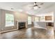 Bright living room with a fireplace and views into the kitchen with pendant lighting and stainless appliances at 4103 Caddy Way, Indianapolis, IN 46268