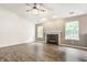 Bright and airy living room featuring a fireplace, windows, and hardwood flooring for a modern appeal at 4103 Caddy Way, Indianapolis, IN 46268