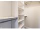 A walk-in closet is designed with white shelving, rods, and ample storage space at 4103 Caddy Way, Indianapolis, IN 46268