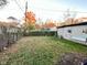 Fenced backyard with mature trees, grass, and detached garage at 4108 Patricia St, Indianapolis, IN 46222