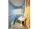 Bathroom featuring blue walls, white fixtures, and a window at 4108 Patricia St, Indianapolis, IN 46222