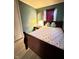 Bedroom with wooden floors and colorful accent pillows at 4108 Patricia St, Indianapolis, IN 46222