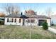 Charming single-story home with an autumn tree and an attached garage at 4108 Patricia St, Indianapolis, IN 46222