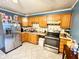 Functional kitchen featuring stainless steel appliances, light wood cabinets, and tiled floors at 4108 Patricia St, Indianapolis, IN 46222